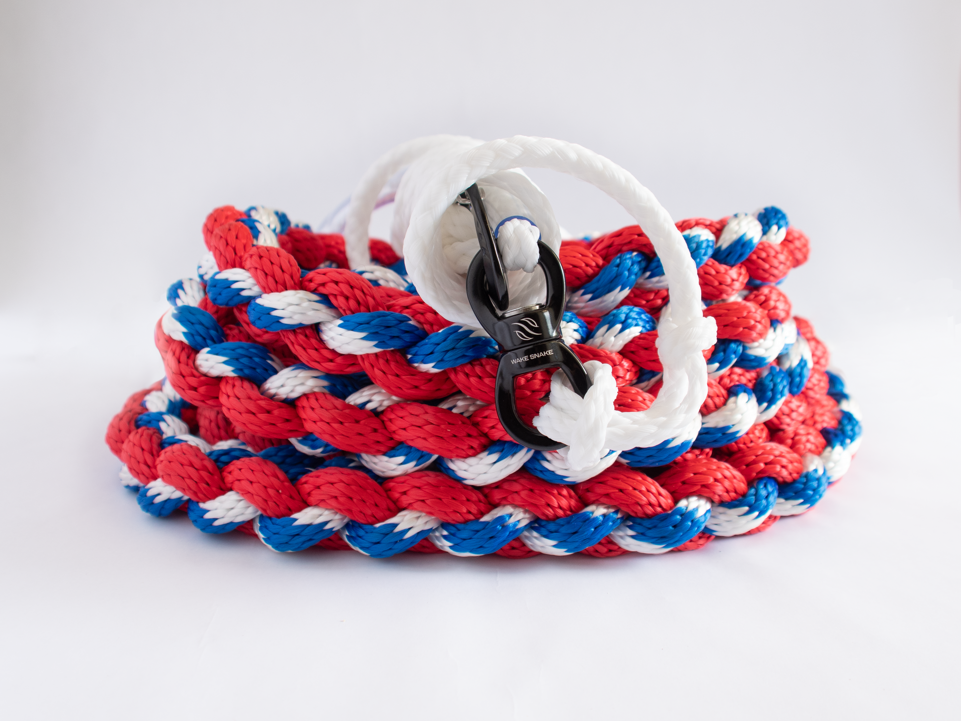 Red white and blue wake surfing rope used to pull a rider behind a boat
