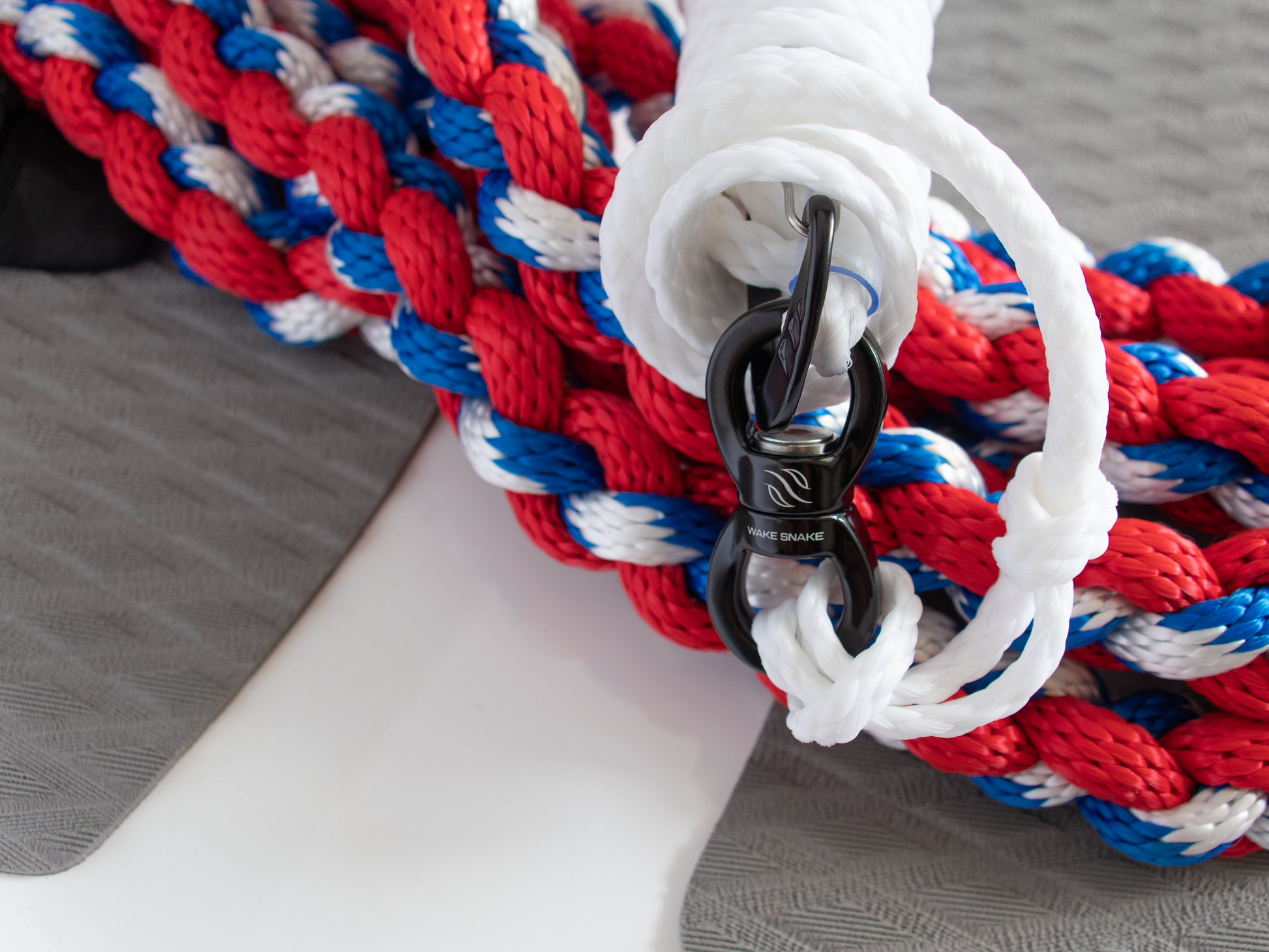 wake surfing rope and swivel carabiner that says 'wake snake' on a surfboard